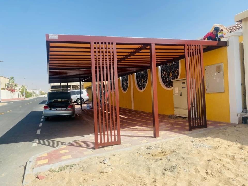 Powder coated aluminium pergola over a luxury villa garden in Dubai
